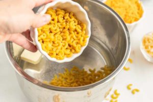 Add the macaroni, water, and butter to the Instant Pot.