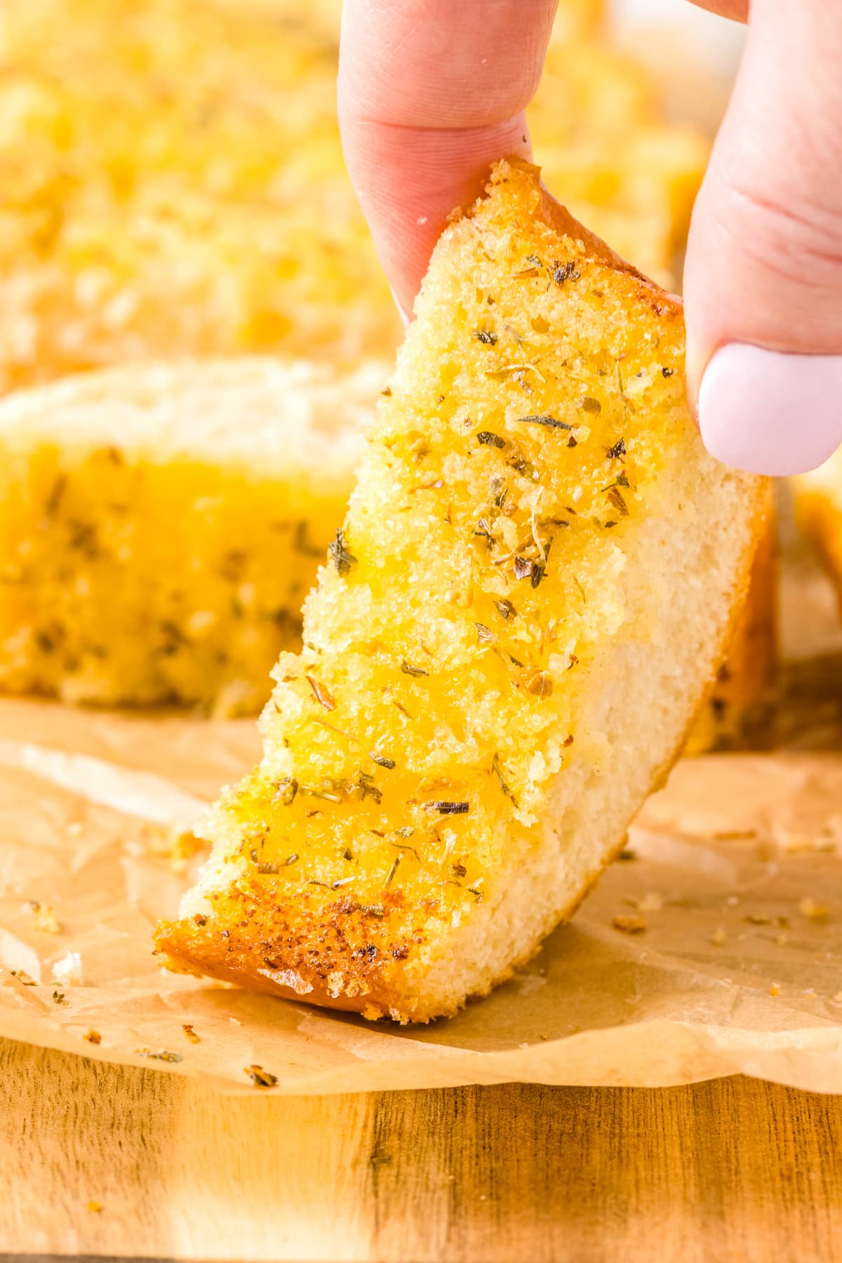 A close up picture of a slice of Garlic Bread.