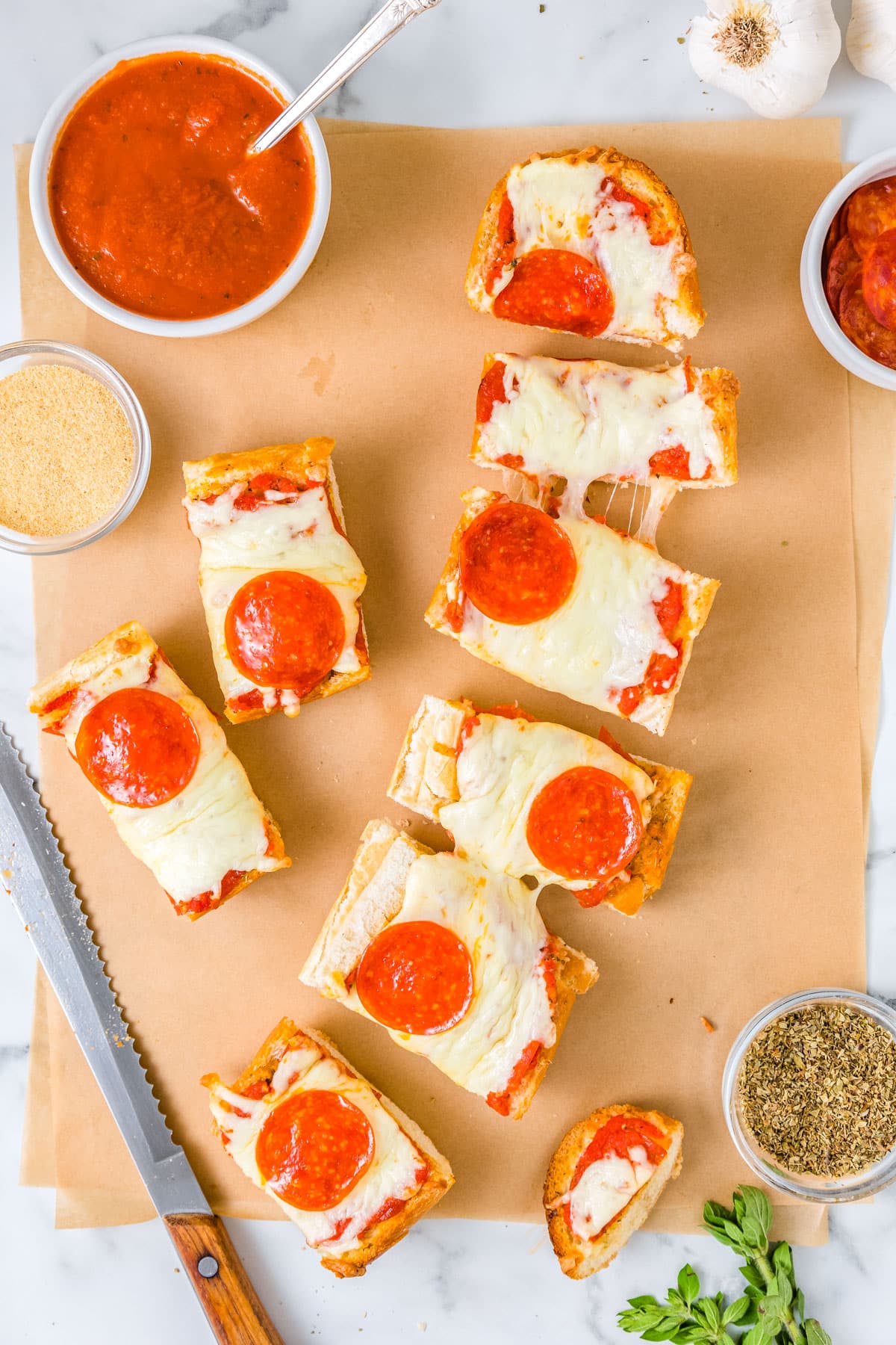 A loaf of bread pizza cut into slices.