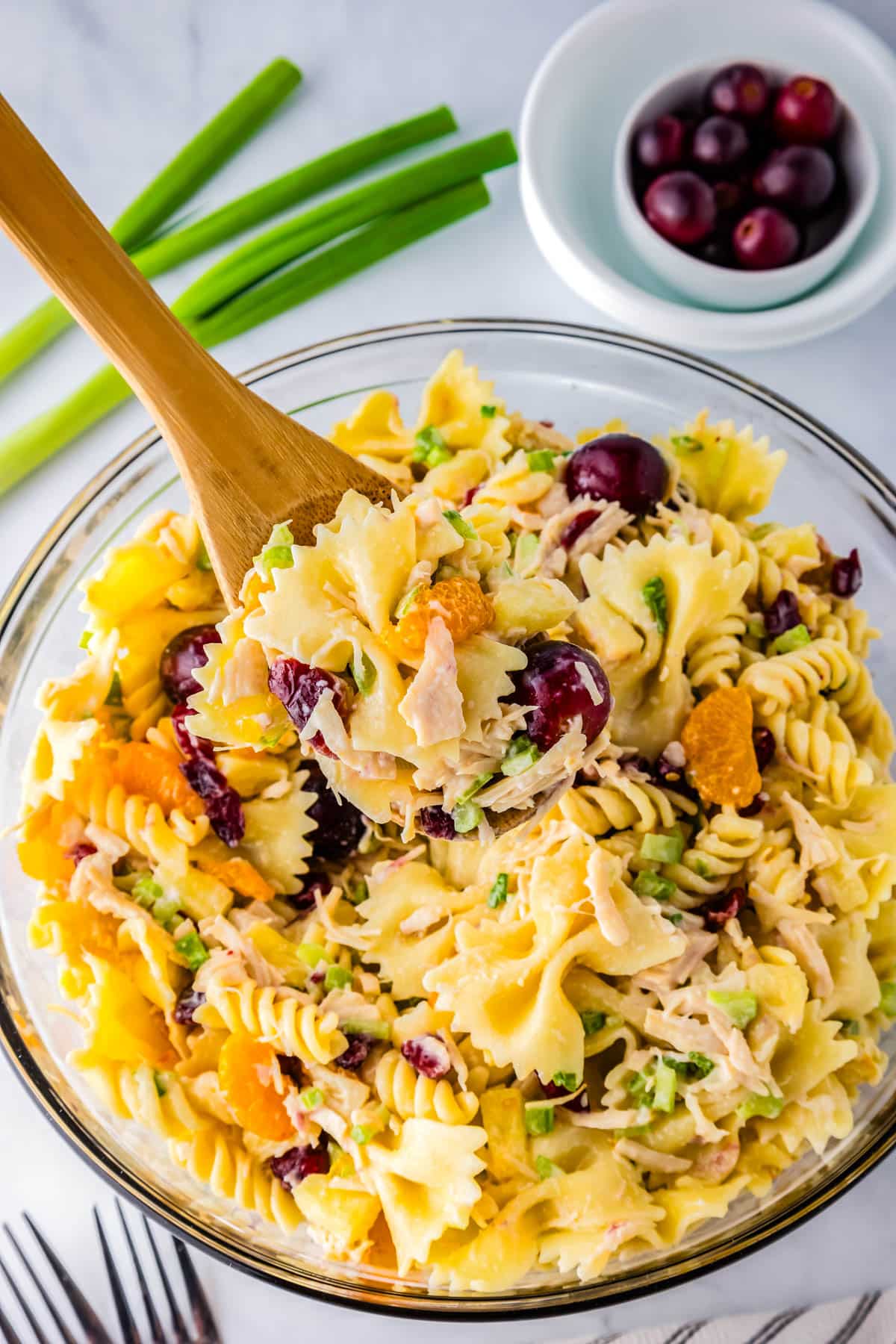 Th finished chicken pasta salad in a glass serving bowl. 