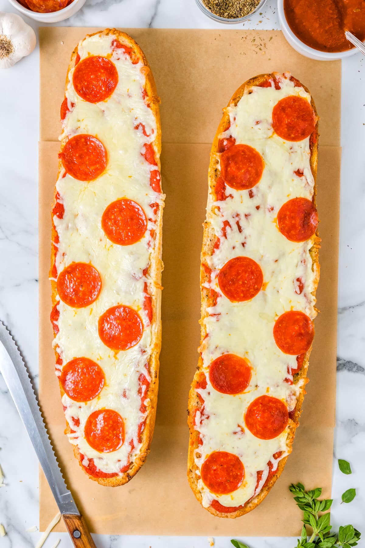 An overhead picture of the finished French Bread Pizza on parchment paper before it's cut into slices.