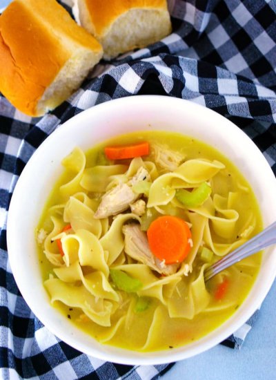 Overhead picture of chicken noodle soup in a bowl with a spoon ready for eating!