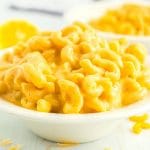 Close up picture of creamy mac and cheese in a white bowl.