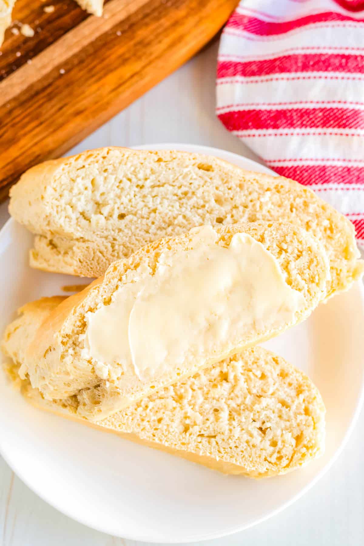 A piece of one hour bread with butter on it.