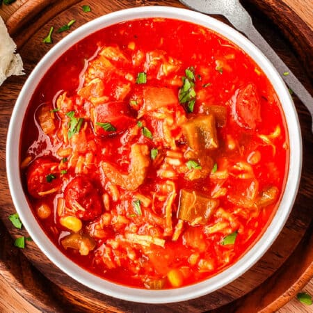 An overhead picture of the finished sausage and chicken gumbo in a white bowl.
