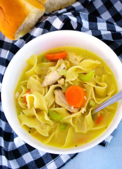 Overhead picture of chicken noodle soup in a bowl with a spoon ready for eating!