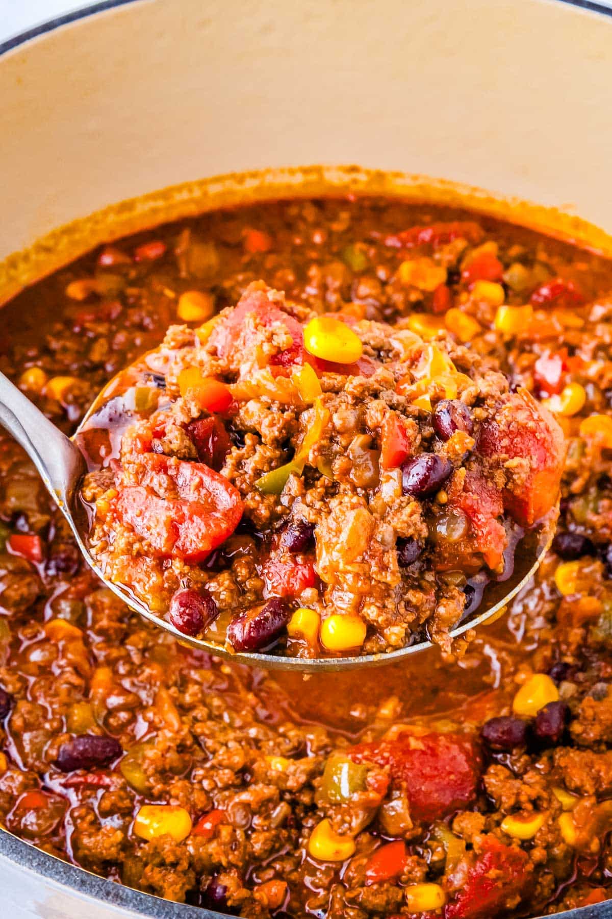 A ladle scooping up some chili.