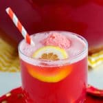 Close up of Cranberry Party Punch in a class with a straw.