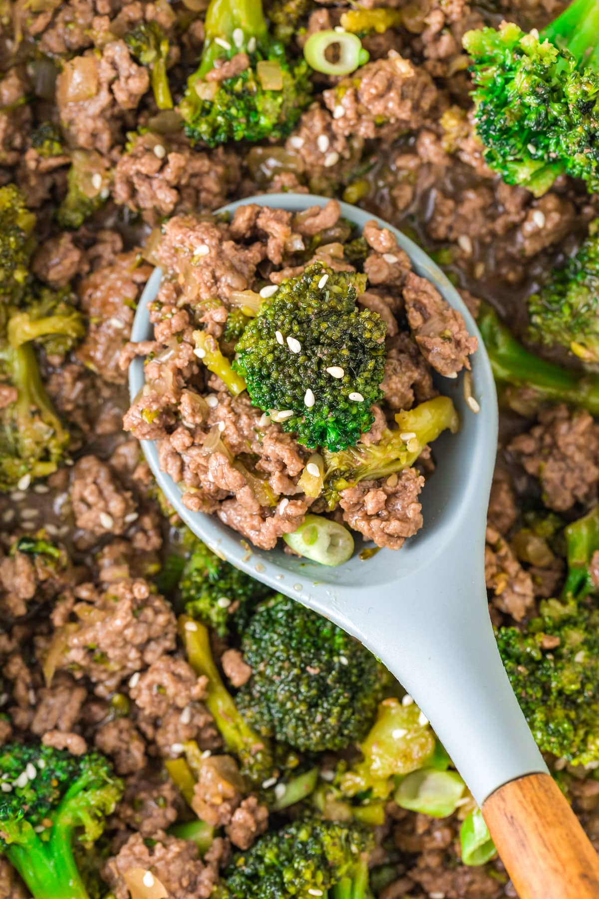 A spoon picking up some of the finished Ground Beef Broccoli.