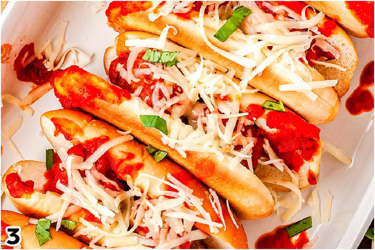 The meatballs spooned into toasted buns and topped with cheese.
