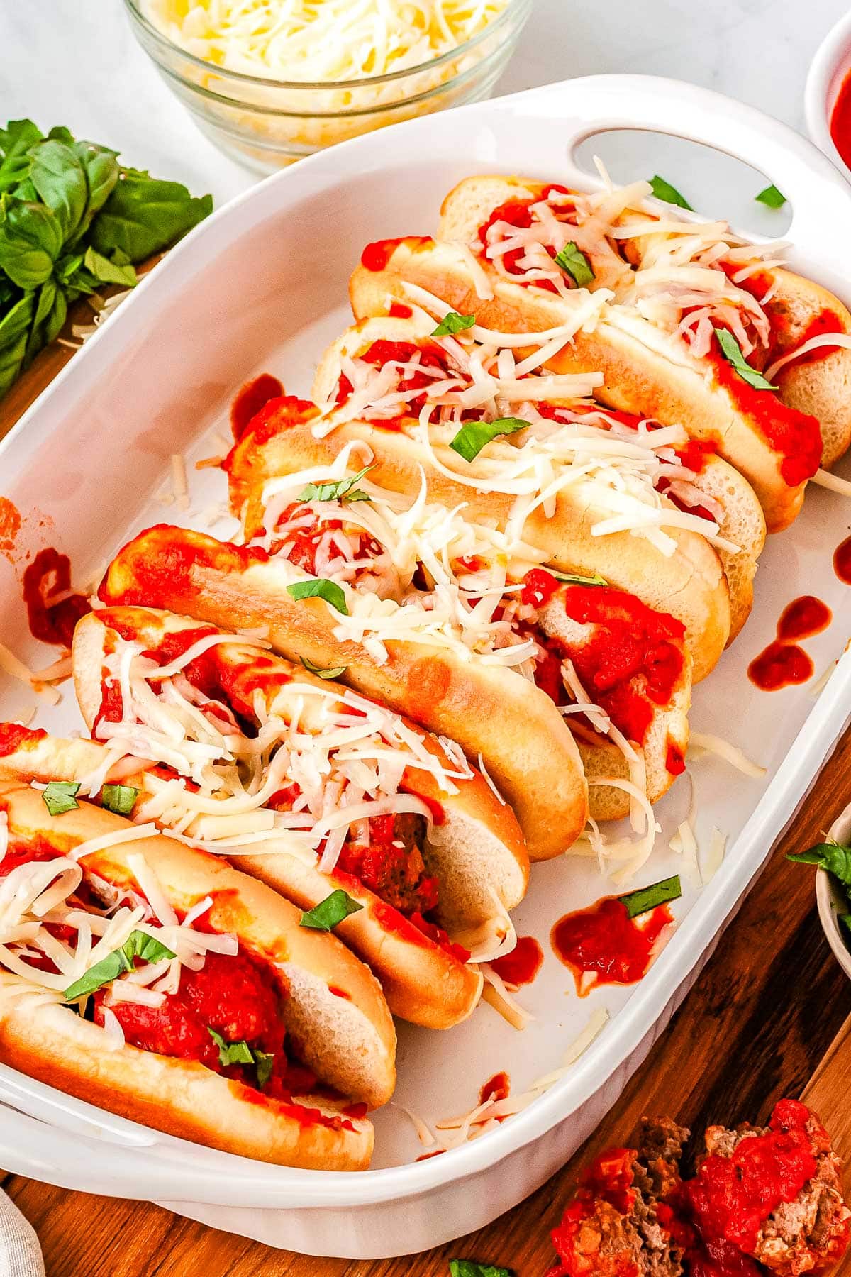 Meatball Subs topped with shredded mozzarella.