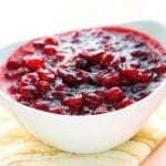 Cranberry sauce with orange juice in a white serving bowl.