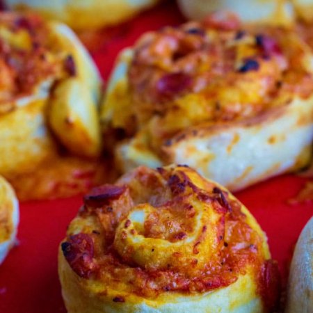 Pizza rolls on a baking sheet.