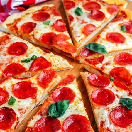 A large homemade pizza cut into slices