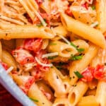 The finished Tomato Alfredo recipe over pasta in a pasta pot.