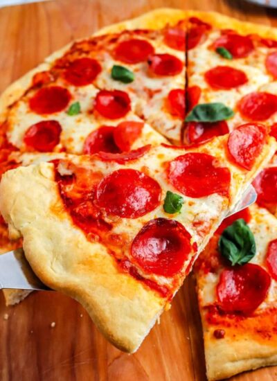 A close up of a slice of pepperoni pizza that's homemade.