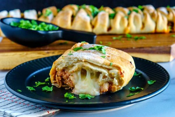 A close up picture of the chicken braid with cheese oozing out.