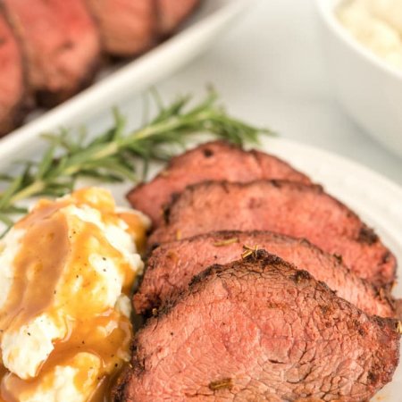 Slices of the roast with mashed potatoes and brown gravy.