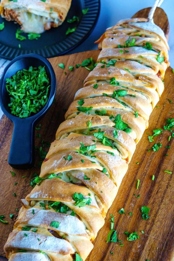 Sprinkle the baked chicken braid with cilantro, slice, and serve.