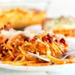 Close up picture of baked spaghetti on a white plate.