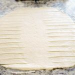 Cut 1-inch slits into the dough.