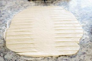 Cut 1-inch slits into the dough.