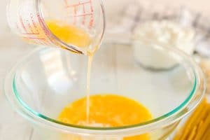 Whisk together melted butter, egg, and Parmesan cheese.