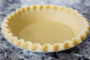 Thaw the pie shell and re-crimp the edges.