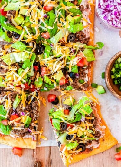 A close up picture of the Crescent Roll Taco Pizza cut into slices.