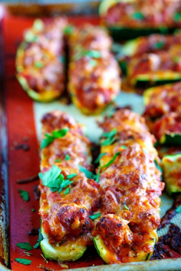 Baked zucchini boats on a cookie sheet. 