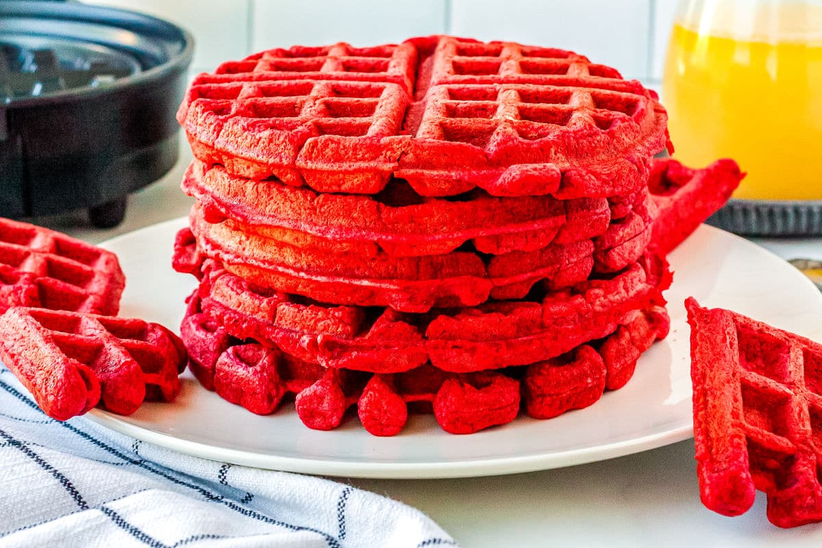 a stack of red velvet waffles on a plate