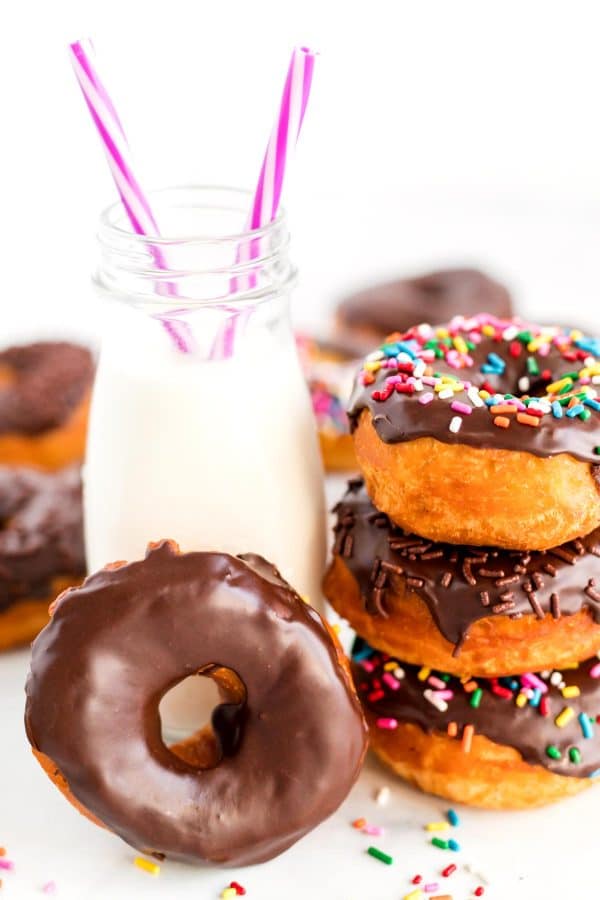 Donuts with a small jug of milk.