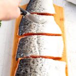 Make 4 slips on the back of the salmon fillets.