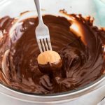 Use a fork to dip the bon bons into the chocolate.