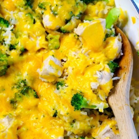 A serving spoon in the cheesy rice.
