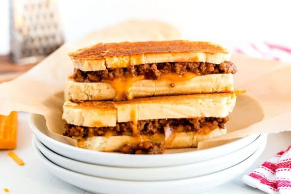 2 grilled cheese sandwiches stacked on top of each other.