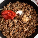 Add the ketchup and other ingredients to the ground beef.