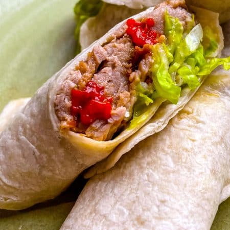 A close up picture of a Machaca Burrito cut in half.