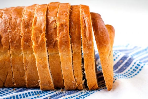Slices of homemade bread stacked next to each other.