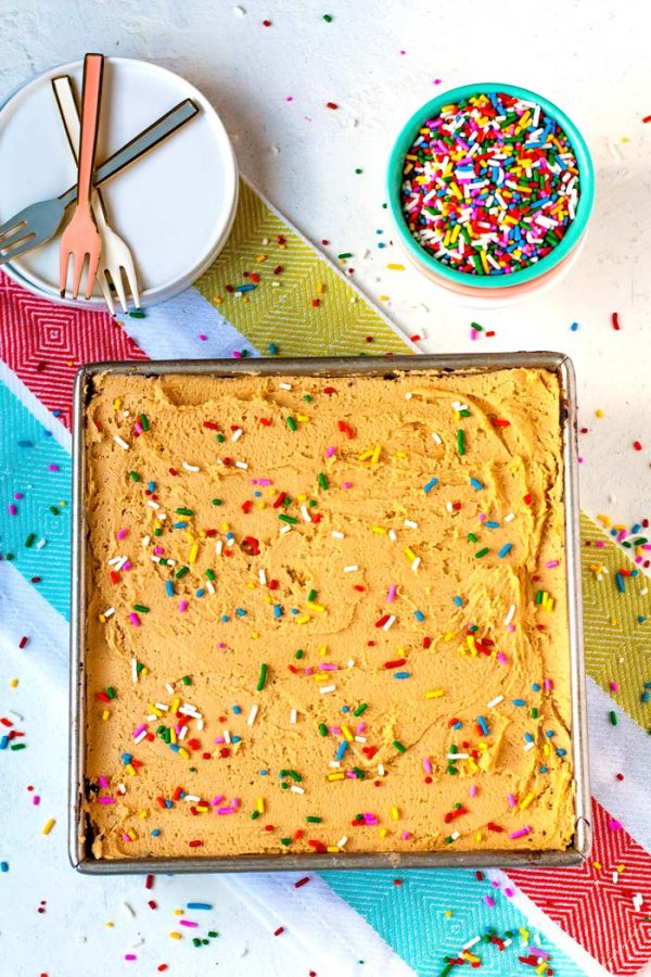 Overhead picture of a chocolate crazy cake with peanut butter frosting and sprinkles. 