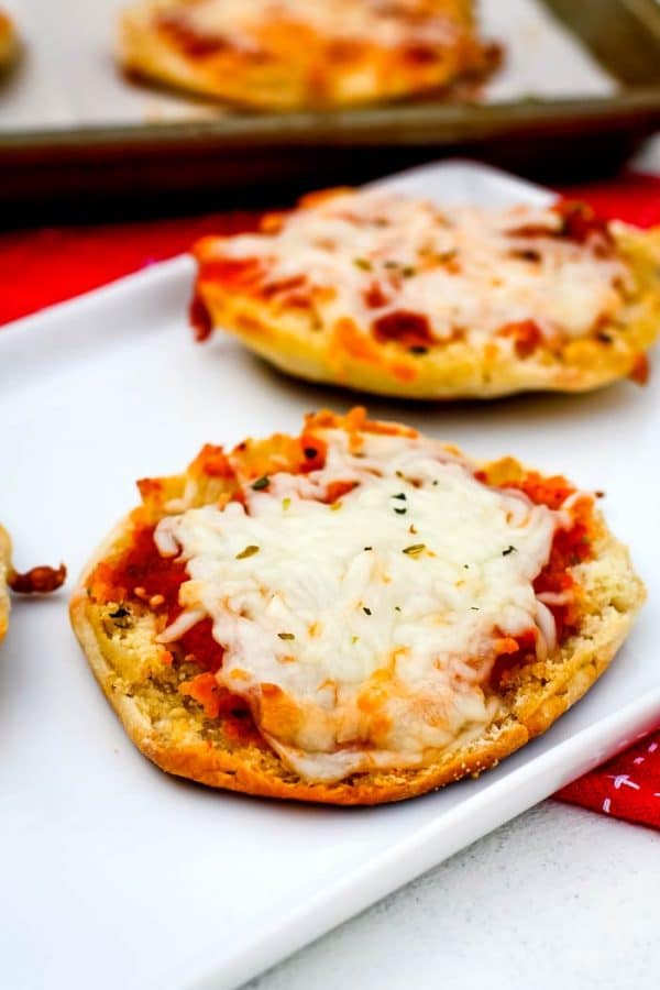 A couple pf English Muffin Pizzas on a white plate.