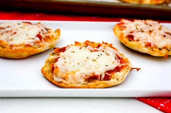 3 English Muffins pizzas on a white serving plate.