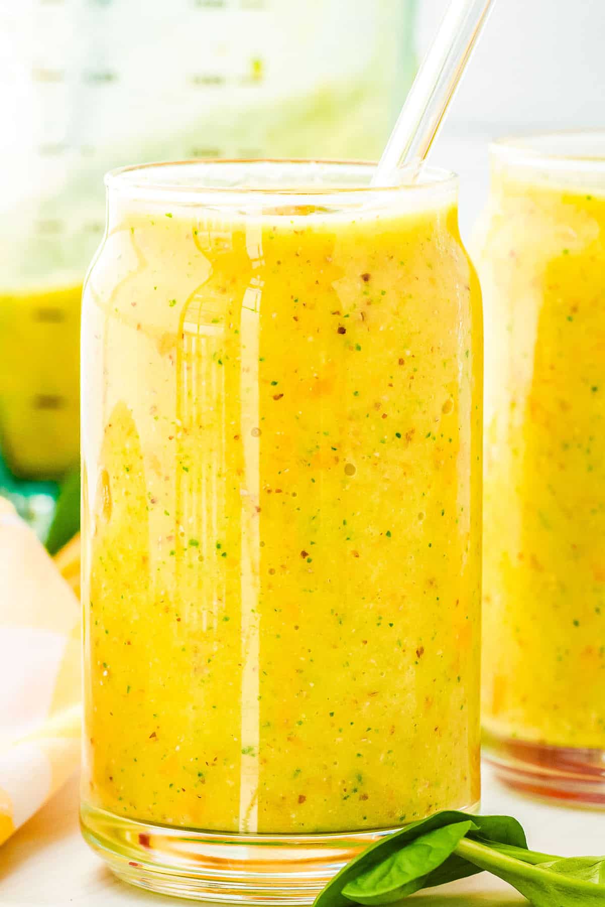 A close-up of Mango Banana Smoothie in a glass