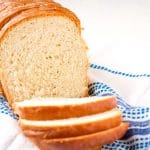 Slices of homemade white bread on a dish towel.