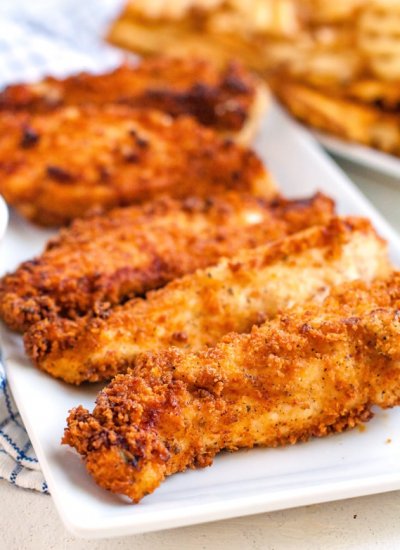 A close up picture of homemade chicken fingers on a platter