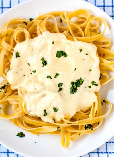 Overhead picture of Copycat Olive Garden Fettuccine Alfredo recipe on a white plate.