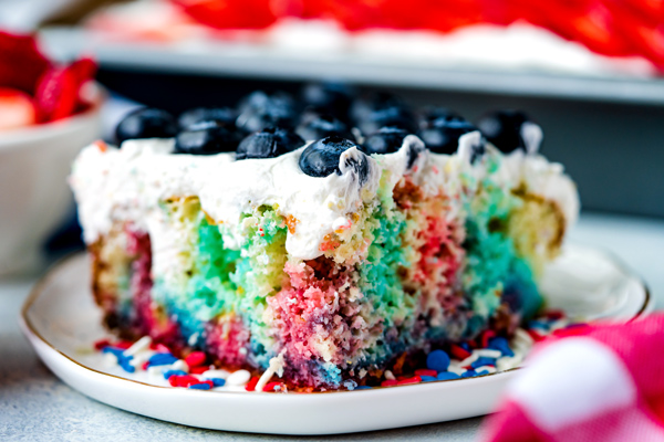 A close up picture of a slice of Jello Poke Cake.