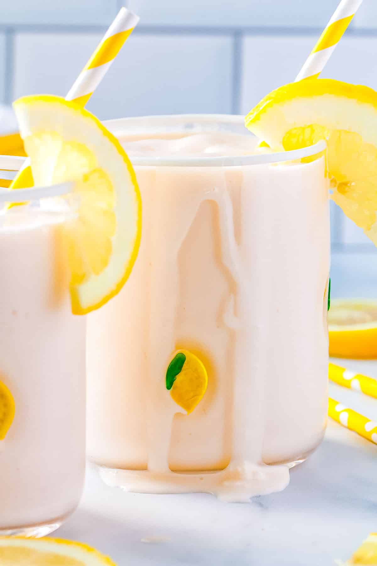 The Frozen Lemonade poured into two clear glases with a little of the mixture dribbling down the side of the glass. 