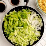 Add the veggies to the hot pan and cook until the onions are translucent and the edges of the veggies are browned.