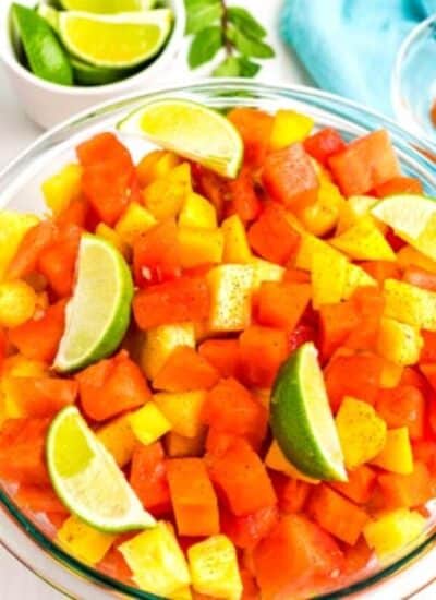 Sprinkle the salad with chile lime seasoning and lime wedges.